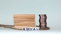 TheÃÂ conceptÃÂ ofÃÂ equalÃÂ laborÃÂ pay. Stacks of coins and miniatures. Royalty Free Stock Photo